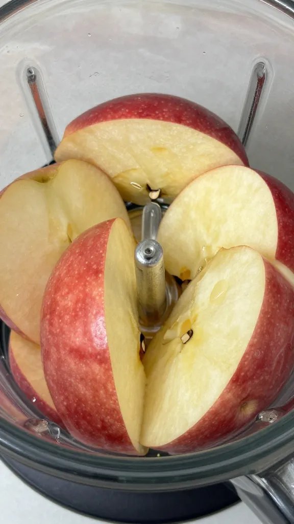**Closeup of crisp red apple slices in a blender**