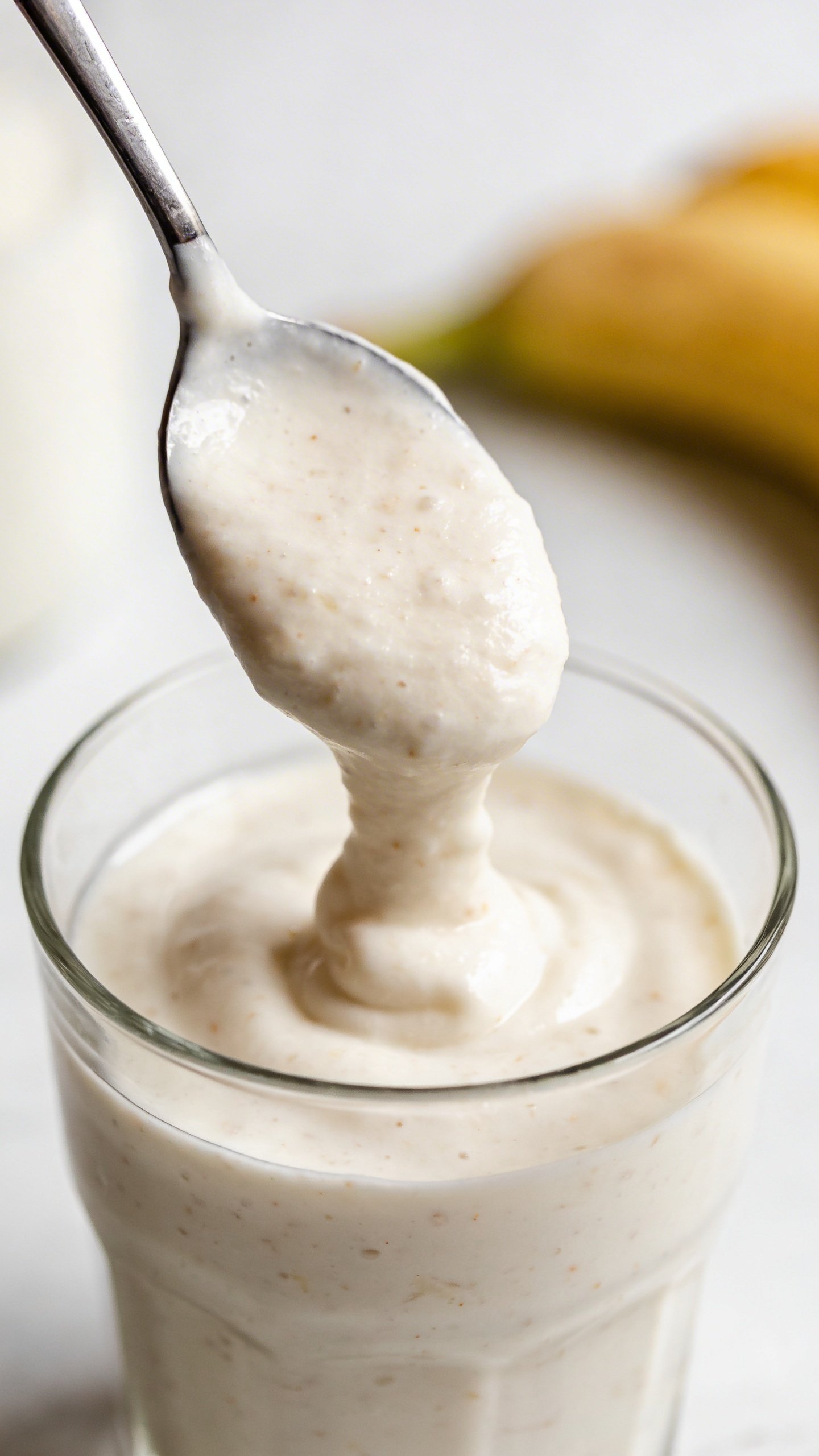 Greek yogurt–banana smoothie, spoonable surface, clean studio background