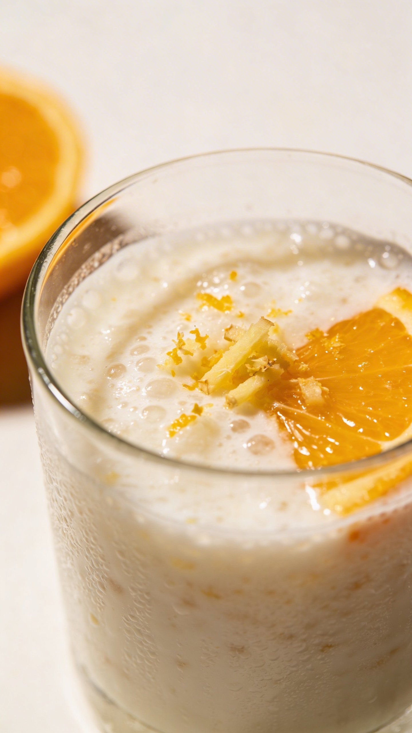 Closeup citrus-ginger immunity smoothie, kefir base, minimal background